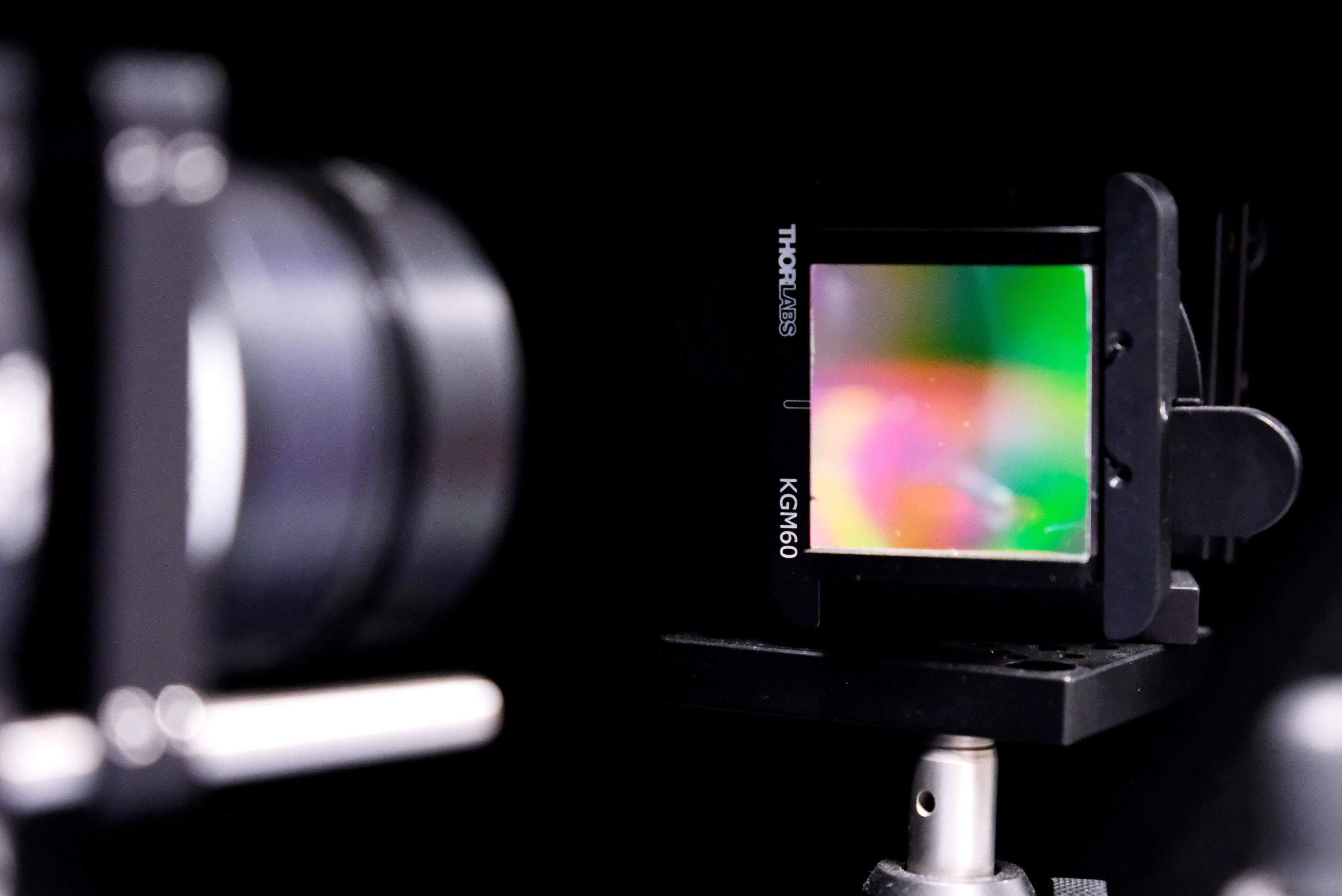 Scientific imaging system analyzing thin-film solar materials through a filter, representing research in photovoltaic technologies, sustainable materials and advanced solar energy device development.