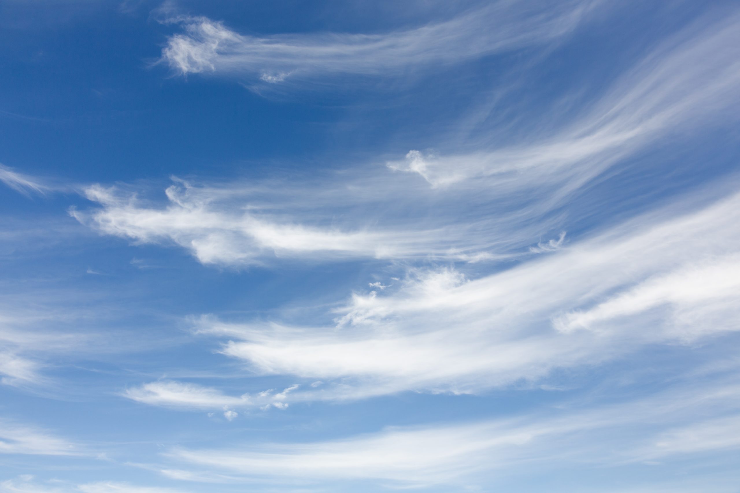 Blue sky with white clouds representing sustainability and clean energy transition