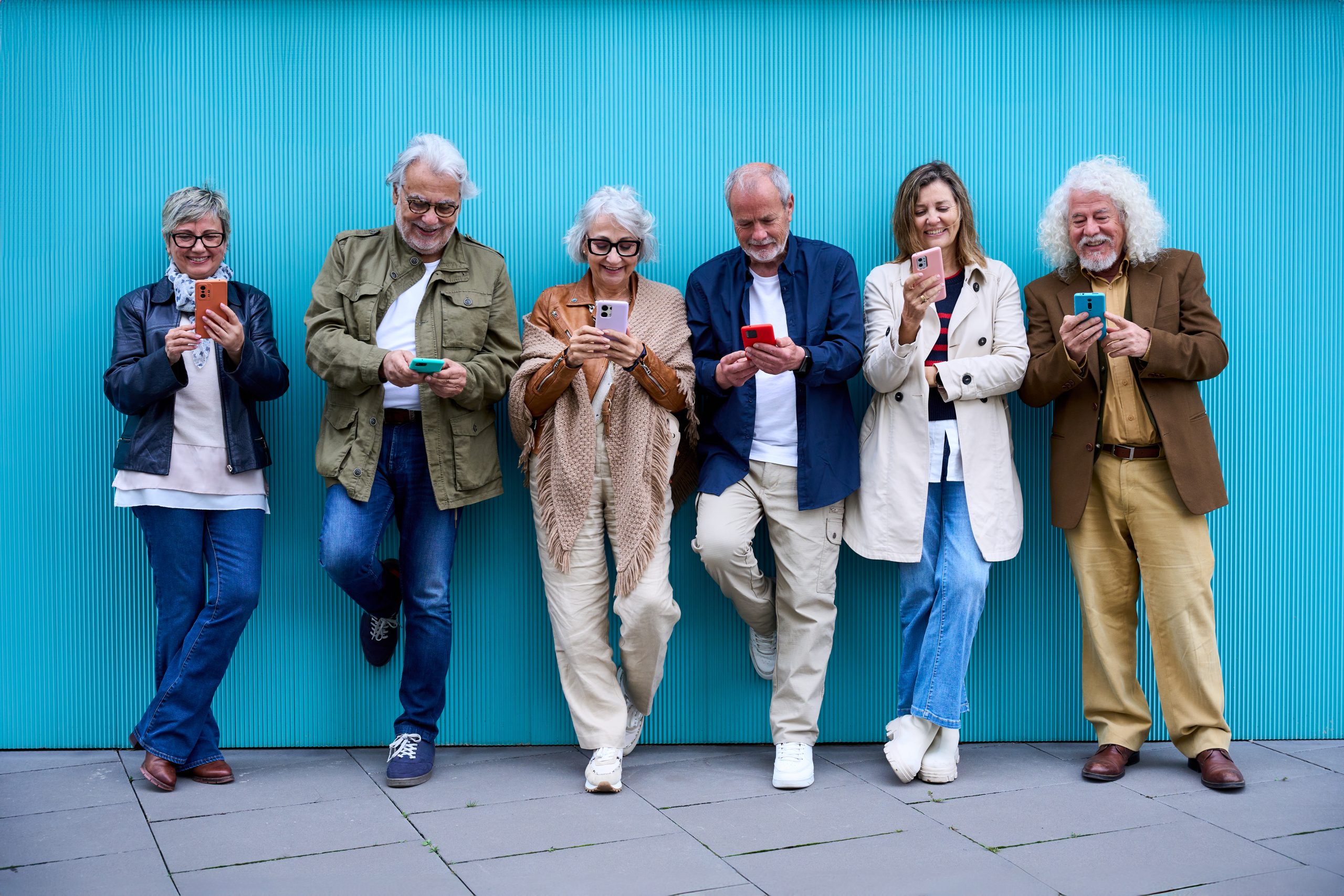 Senior adults using smartphones to access digital services and connectivity