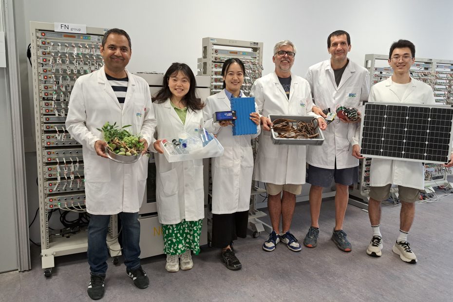 Researchers in a battery laboratory holding reused, recycled and surplus materials related to circular battery production