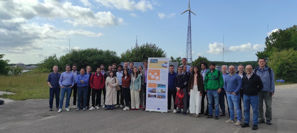 Participants of the FLOW project gathered at an energy infrastructure site during a project meeting.